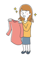 気に入った服を見つけた買い物中の女性