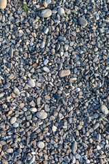 Crushed stone on the seashore. Selective focus on object. The stones were laid on the ground in the garden as a background. Background blur. Pebble stones background.