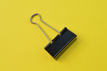 Paper clip isolated on a yellow background