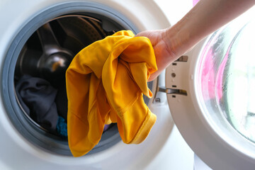 Woman's hand Pick up clothes Washing machine.Clean and Healthy Concepts.
