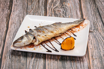 Grilled seabass fish served lemon