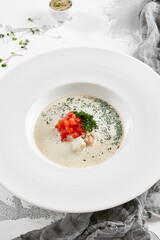 Fish creamy soup in norwegian style. Finnish fish soup with tomato, dill and creamy. Scandinavian food - salmon creamy soup. Seafood chowder with vegetables and fish. Norwegian cuisine.