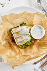 White fish fillet with broccoli in rustic style. Healthy eating: cooked fish fillet with vegetables...