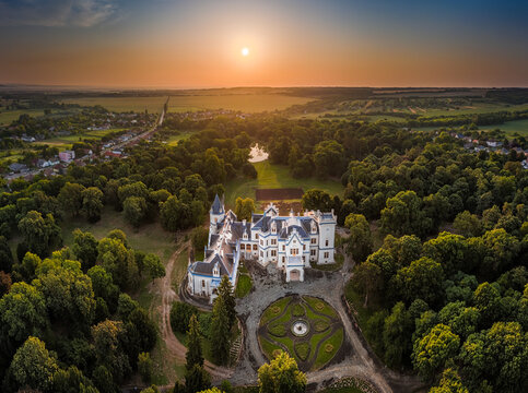 Nadasdladany, Hungary - Aerial panoramic view of the beautiful renovated Nadasdy Mansion (Nadasdy-kastely) at the village of Nadasdladany with rising sun, warm sunlight and blue sky on summer morning
