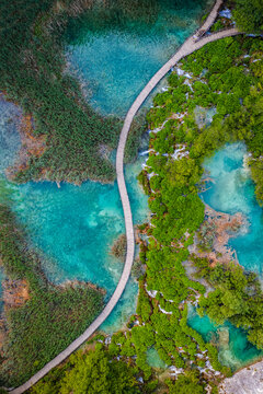 Plitvice, Croatia - Aerial top down view of a wooden walkway in Plitvice Lakes National Park on a bright summer day with turquoise water and small waterfalls