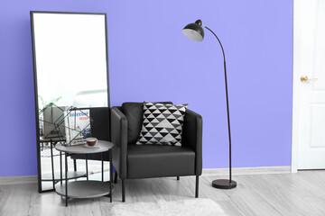 Modern interior of room with coffee table, mirror, lamp and armchair