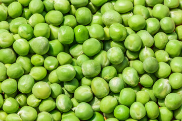 Close up view of fresh raw peas. Healthy organic green raw peas.