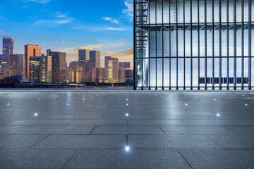 Fototapeta na wymiar Empty square floor and city skyline with modern commercial buildings in Hangzhou at sunset, China.