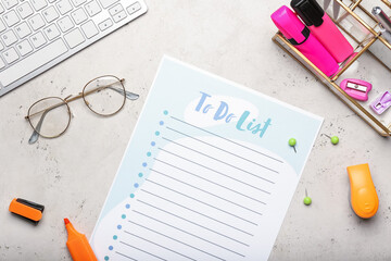 Blank to do list, keyboard, eyeglasses and stationery on grunge background