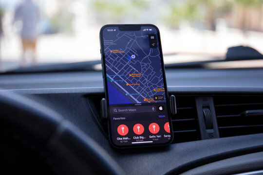  iPhone 13 with Apple Maps on the screen in car