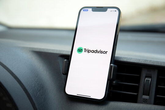 iPhone 13 with social networking service Tripadvisor in the Car