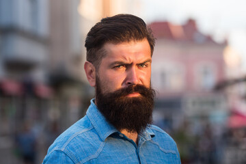 young handsome bearded hipster man in the city.