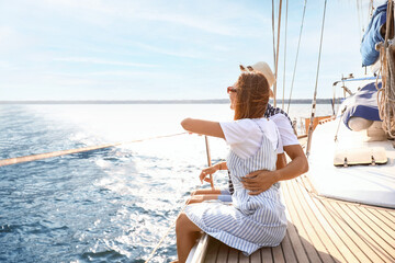 Happy young couple resting on yacht