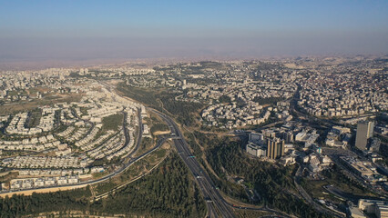 Obraz premium Jerusalem north east city panorama with traffic, aerial view Drone view of mount (har) hotzvim and city traffic, may, 2022 