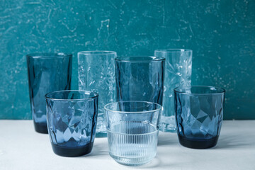 Different empty glasses on table