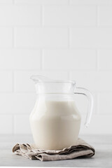 Jug with vegetable milk on a light background. The concept of alternative milk for a healthy lifestyle.