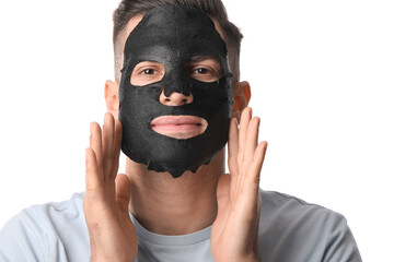 Handsome man with black facial mask on white background, closeup