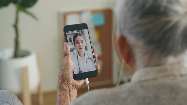 Asian senior woman grey hair 80-90s video call with doctor, telemedicine telehealth concept