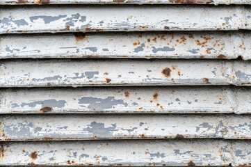 Repeating white and gray stripes of metal. Parallel rusty iron stripes. Abstract multitasking background.