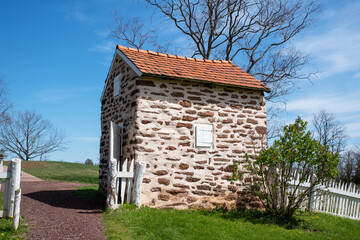 Fototapeta na wymiar Colonial American stone smokehouse in idyllic landscape