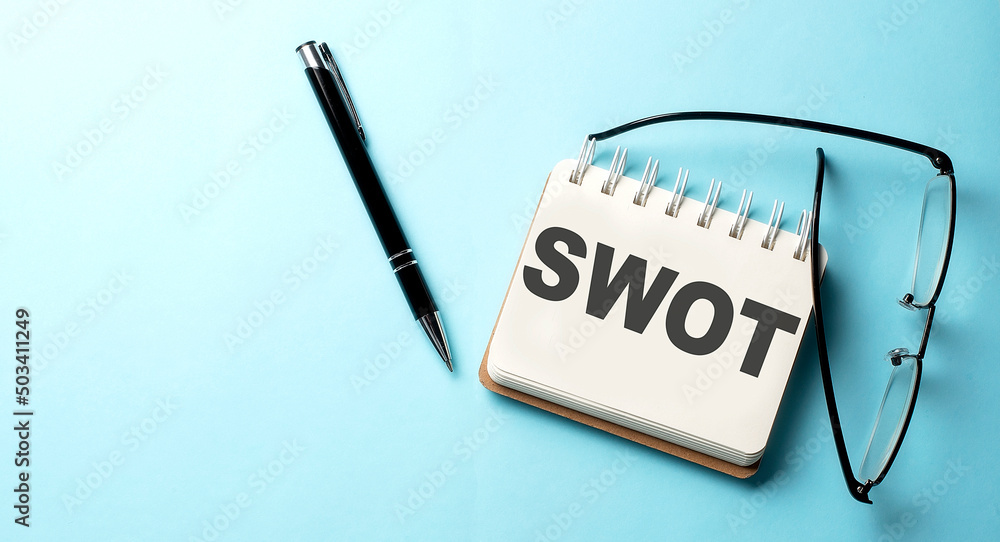 Poster swot text written on a notepad on the blue background