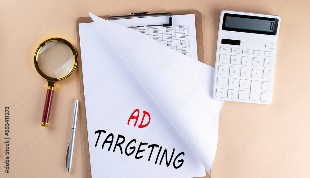 Poster clipboard with chart and text ad teargeting with magnifier ,calculator on beige background