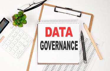 Office desk table with paper sheet, notepad ,chart and calculator. Top view DATA GOVERNANCE