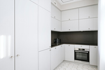 White wooden kitchen during bright day