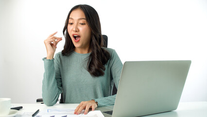 Cheerful freelance Asian woman thinking get idea work using laptop pc on desk over white background. Student young girl use computer think something comfortable network online over isolated.Technology