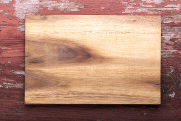 Empty cutting board on a wooden background. Top view.