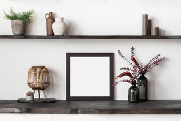 Blank picture frame mockup on white wall. Artwork in interior design. View of modern rustic...