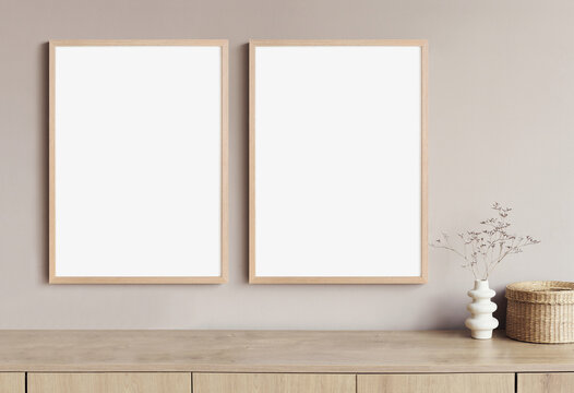 Blank frame mockup in modern interior design with vase and trendy plants on empty white wall background, Two vertical templates for paintings, photos or posters. Artwork mock-up