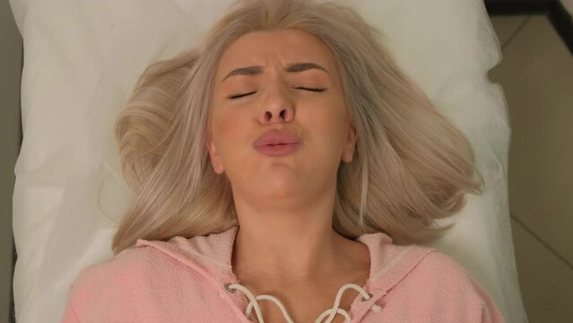 Silhouette of a sexy girl dancing an erotic sensual dance in blue smoke.