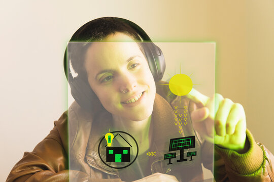 Happy freelancer wearing headphones analyzing design on transparent screen