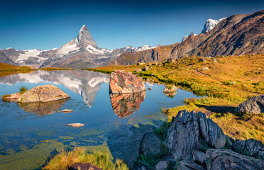 Exotic summer scene of Stellisee lake. Superb morning view of Matterhorn (Monte Cervino, Mont...