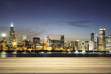 Empty wooden table top with beautiful Chicago skyscrapers at evening on background, mock up