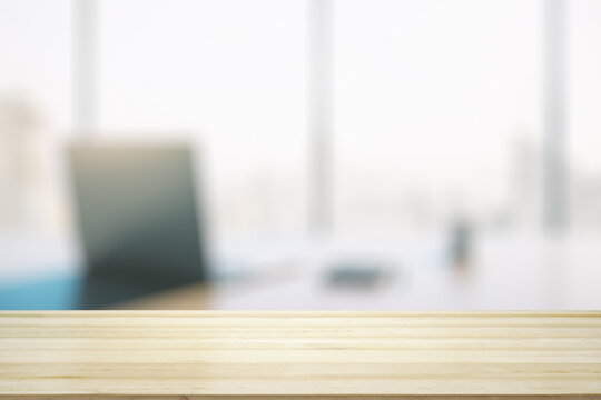 Empty office wooden table with empty space on modern workplace with computer background, closeup, mock up