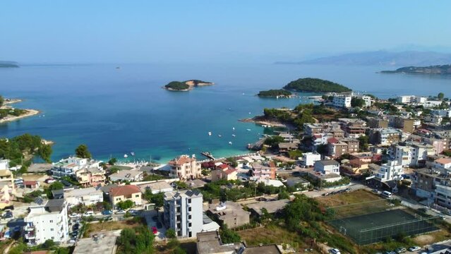 Drone shot of Ksamil, Albania - drone is flying towards some islands, passing hotels and beaches. Snippet could ideally be used for travel related videos or movies.