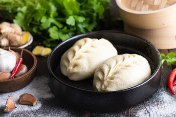 Traditional Korean steamed pie, pyanse or pigodi, on dark wooden background, selective focus