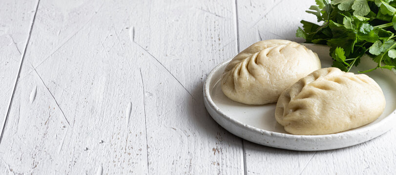 Traditional Korean steamed pie, pyanse or pigodi, on white wooden background, selective focus, copy space