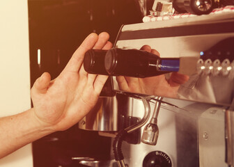a barista prepares coffee on a coffee machine in a cafe