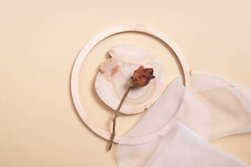 Still life composition with dry rose and wooden decor. flat lay