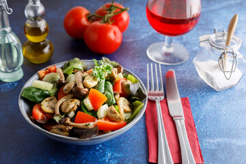 Summer meal a salad with himeji, oyster fungus, white Paris mushrooms mixed with young lettuce, tomatoes and cucumber.
