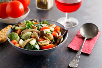 Summer meal a salad with himeji, oyster fungus, white Paris mushrooms mixed with young lettuce, tomatoes and cucumber.