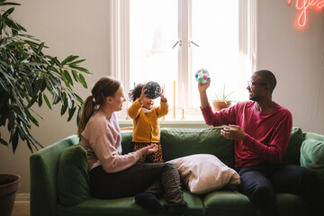 Parents playing with daughter at home