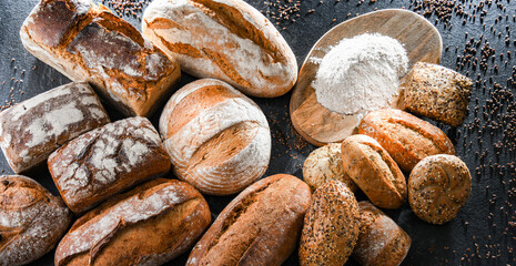 Assorted bakery products including loafs of bread and rolls