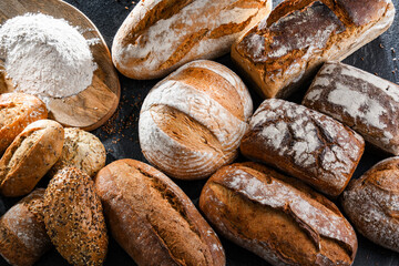 Assorted bakery products including loafs of bread and rolls
