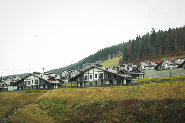 Ski resort with modern houses, ski lift and others in autumn