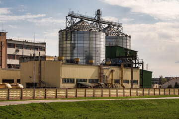 Obraz premium agro silos granary elevator on agro-processing manufacturing plant for processing drying cleaning and storage of agricultural products, flour, cereals and grain.