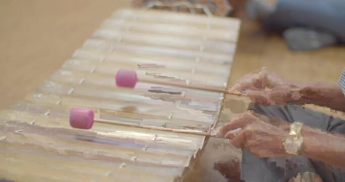 Thai musical instruments. The alto xylophone make a soft sound accompaniment to the rhythm of the music. ( close up hands )